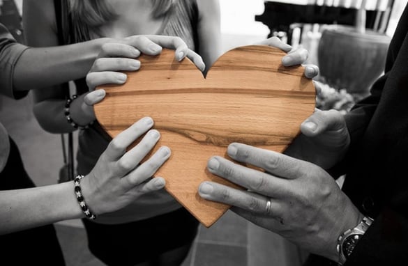Team Holding a Wooden Heart | Pure Flix